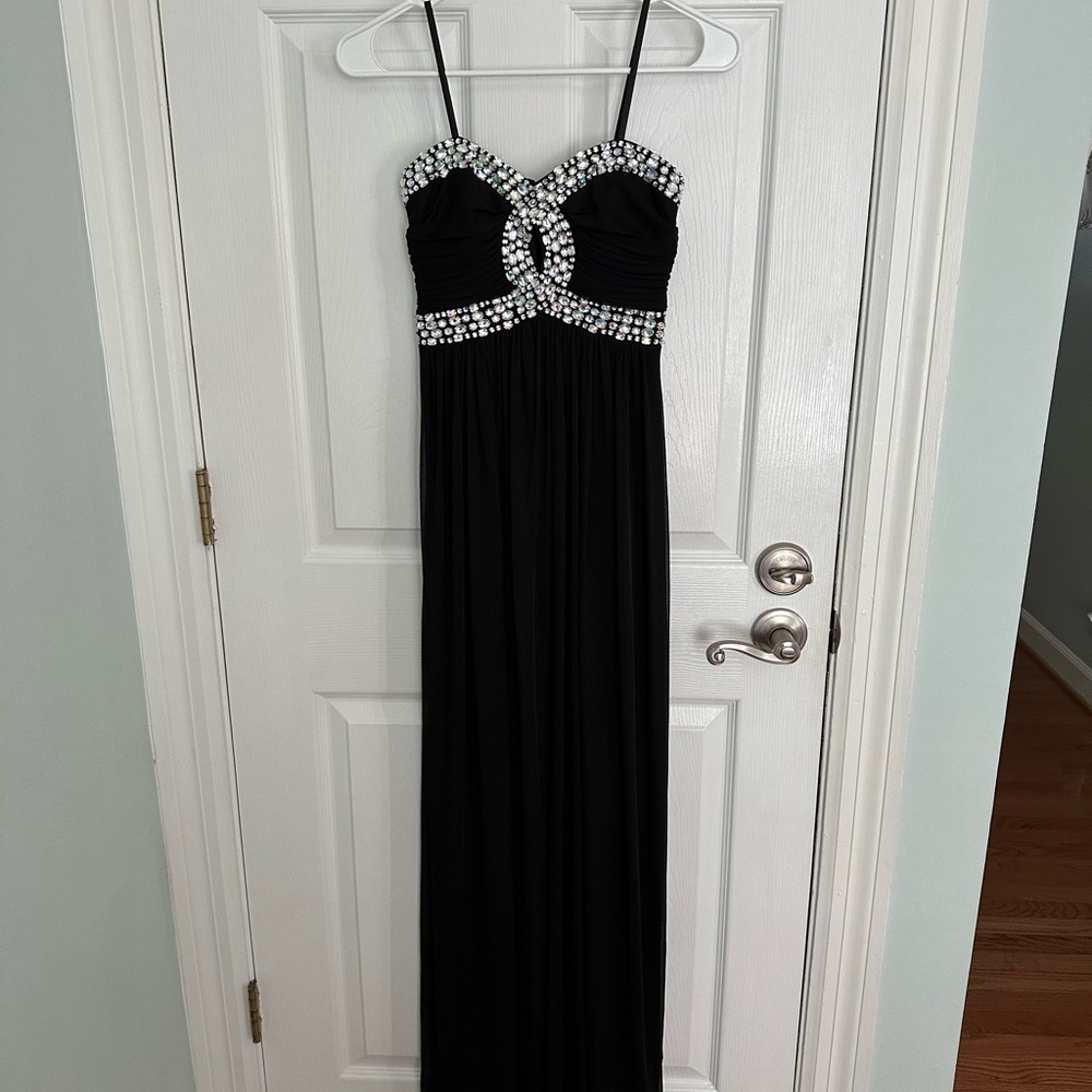 New-floor length black dress with embellishments. Strap or strapless. Size 1